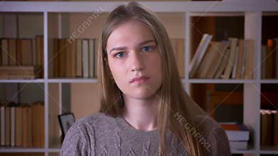 Closeup portrait of young attractive female student waving her head saying no with anger looking at camera in the