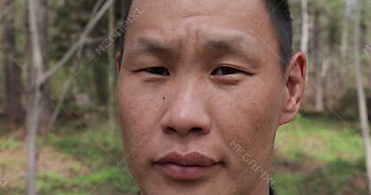A representative of small and indigenous peoples of the far north - a Udege, looking directly at the camera.