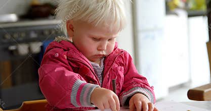 Girl drawing with crayon on a paper at home 4k