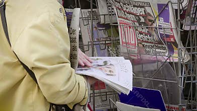 Newspaper kiosk stand with woman shopping for press international