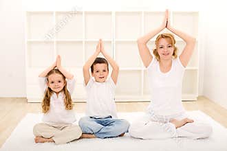Family doing yoga exercises