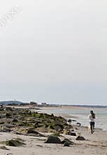 Duxbury, Massachusetts. Beautiful early spring view of Duxbury beach at sunset with people walking on the beach