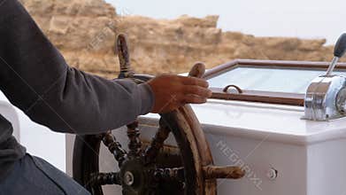 Captain at the Steering Wheel of a pleasure boat. Captain controls the sea yacht