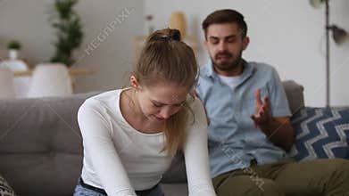 Upset young woman crying husband despot shouting at wife