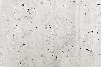 Concrete wall as gray coarse facade made of natural cement with holes and imperfections empty rustic texture concrete background