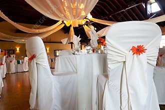 Wedding venue, covered chairs & ceiling decoration