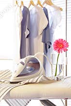 Iron on ironing board in laundry room