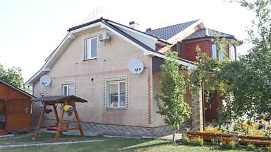 Beautiful exterior of newly built luxury home. Yard with green grass