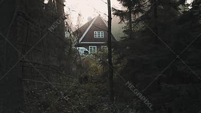 Little wooden house cabin in deep woods, warm light