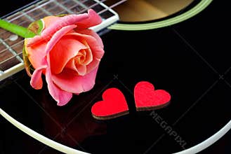 Hearts of lovers, beautiful rose and black acoustic guitar.
