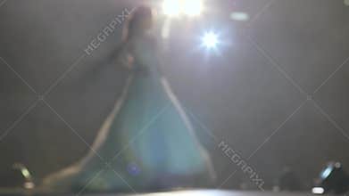 White wedding dress on model in spotlight at nightly stylish show, fashion business