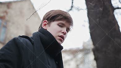Hurt look of young man left by parents, teenage orphan suffering loneliness