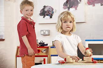 Two Young Children Playing Together at Montessori/