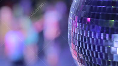 Disco ball in strobe lights at night club party, people dancing