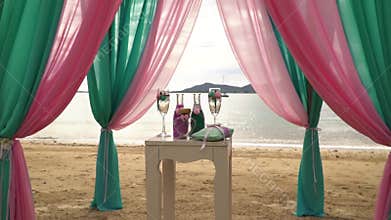 Beautiful wedding arch and decorations on the beach among the palm trees.