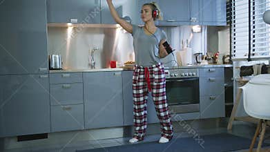 Woman singing and dancing in kitchen
