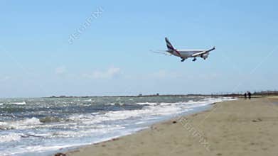 Aircraft flying over beach. Airplane arrival. Hijacked plane crash. Terrorism