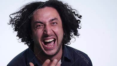 Close up of young angry man screaming isolated on white background. Close up portrait of young man screaming. Very angry