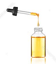 Drop falls from a pipette into a cosmetic bottle