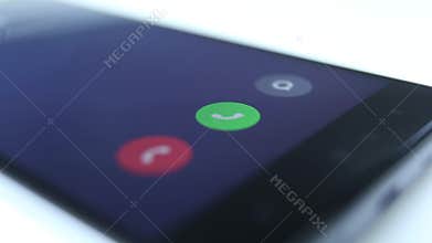 Incoming phone call indication on smartphone display close-up, Answering an incoming call