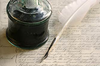 Feather quill pen and inkwell