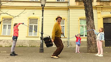 Old man rope skipping with three girls.