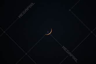 New moon in the dark sky