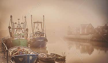 Boats on a foggy river.