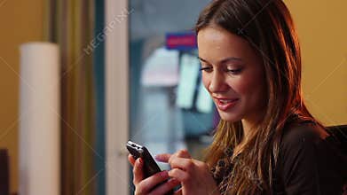 Virtual flirt young attractive lady sending mobile phone message