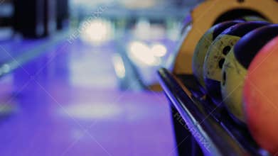 Bowling balls with bowling alley in background