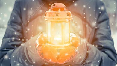 Female holding red candle lantern withwith yellow luminous light