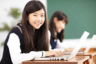 Teenager student learning online with laptop in classroom