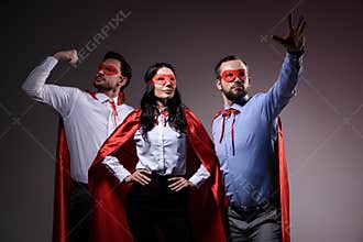 super businesspeople in masks and capes showing superpower