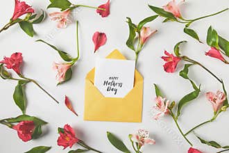 beautiful pink flowers and happy mothers day greeting card on grey