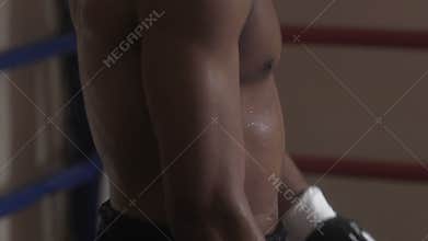 Sweaty fighter warming up muscles before boxing fight for title of champion