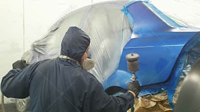 Professional car painter in vehicle workshop