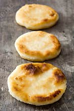 Arepas on wooden table. Venezuelan typical food