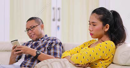 Angry woman grabbing her boyfriend cellphone