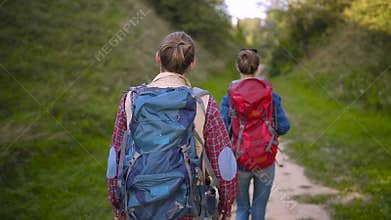 Tourist couple traveling, walking in nature.