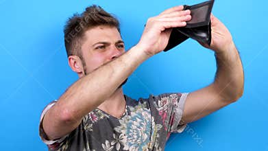 Man looks happy and smiling to the camera then he looks down at his wallet and realises that he has no money
