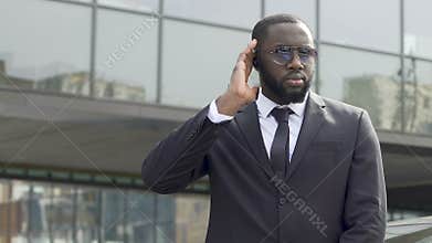 Bodyguard awaiting appearance of governmental motorcade inspecting territory