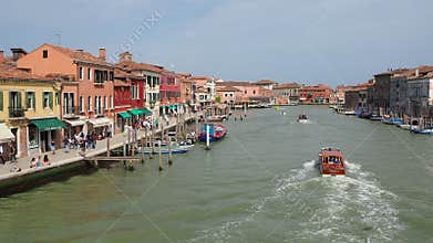 Murano, Venezia, Italy. View on canal with boats and the traditional houses