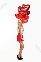 blond woman with red heart balloons