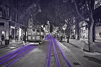 San Francisco street car at night black and white with purple accent.