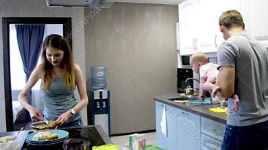 Mom and Dad have fun with their newborn baby