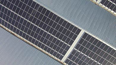 Aerial view of solar electricity plant on a roof top of industrial building - renewable source of energy