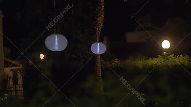 House yard with Chinese lanterns at night