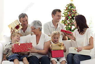 Happy family at home opening Christmas presents