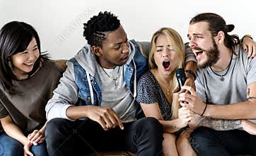 Friends having fun singing karaoke