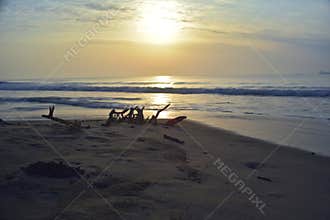 Beautiful long exposure photography of sunrise at sea shore with sea water coming over the sand